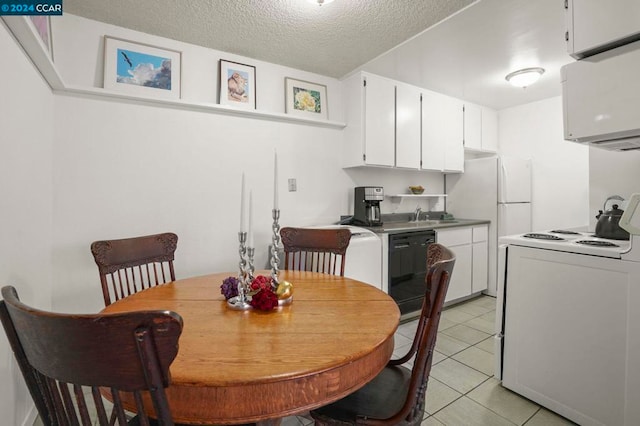 tiled dining area featuring sink and a textured ceiling