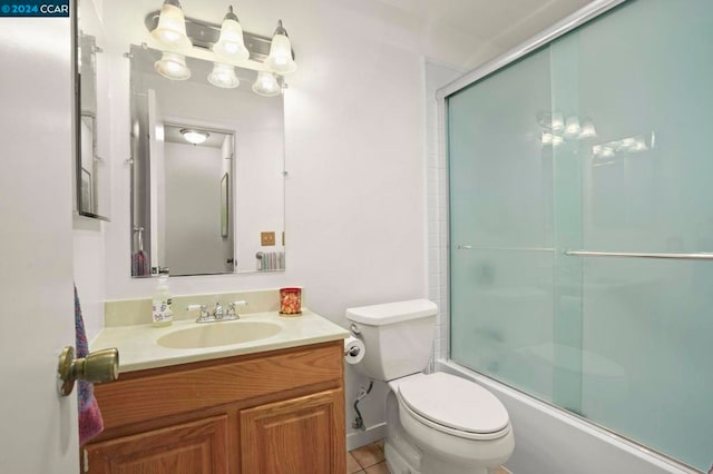 full bathroom with enclosed tub / shower combo, tile patterned floors, toilet, and vanity