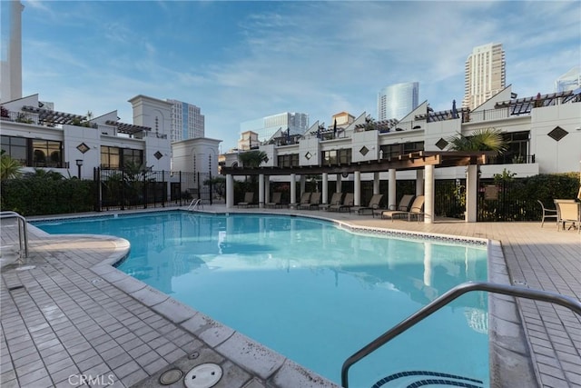 pool with a city view and a patio area