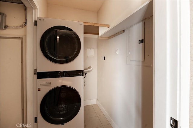 700 W Harbor Dr Unit 104, San Diego, CA 92101 - laundry room featuring stacked washing machine and dryer, electric panel, and tile patterned flooring