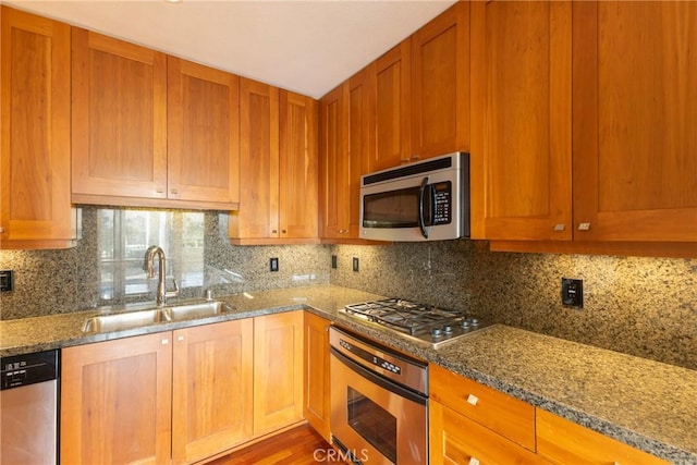 700 W Harbor Dr Unit 104, San Diego, CA 92101 - kitchen with stainless steel appliances, light stone countertops, and decorative backsplash
