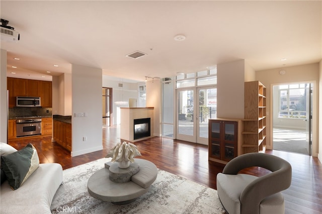 700 W Harbor Dr Unit 104, San Diego, CA 92101 - living room featuring dark wood finished floors, french doors, a multi sided fireplace, and recessed lighting