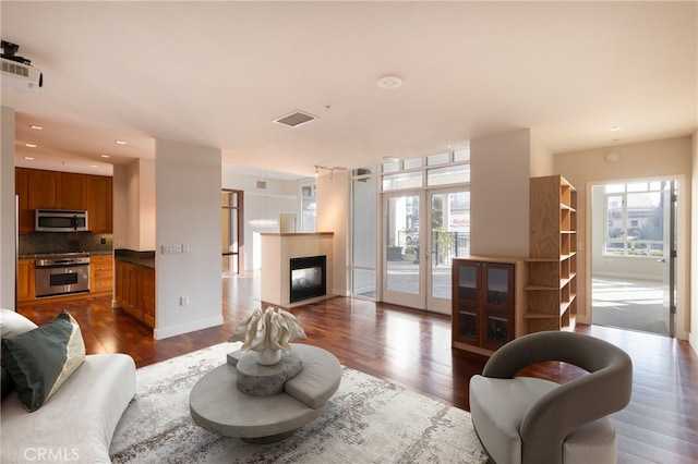 700 W Harbor Dr Unit 104, San Diego, CA 92101 - living room with dark wood finished floors, french doors, a fireplace, and recessed lighting