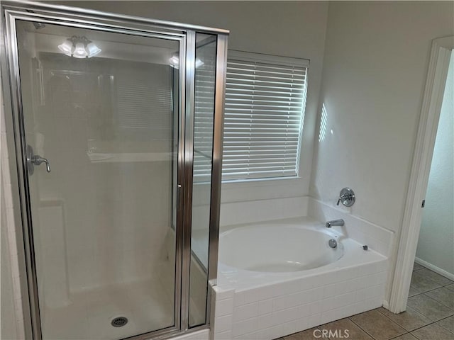 bathroom featuring tile patterned floors and shower with separate bathtub