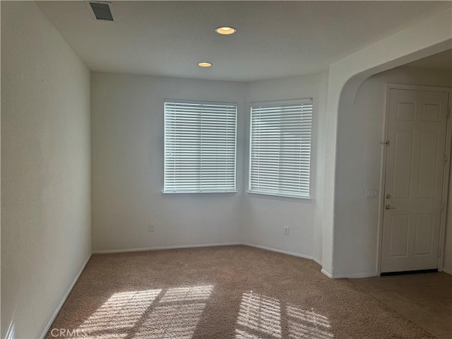 empty room featuring light carpet