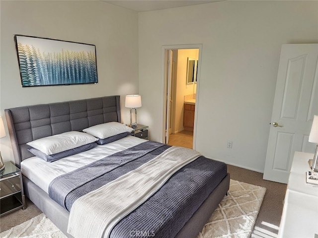 carpeted bedroom with ensuite bath