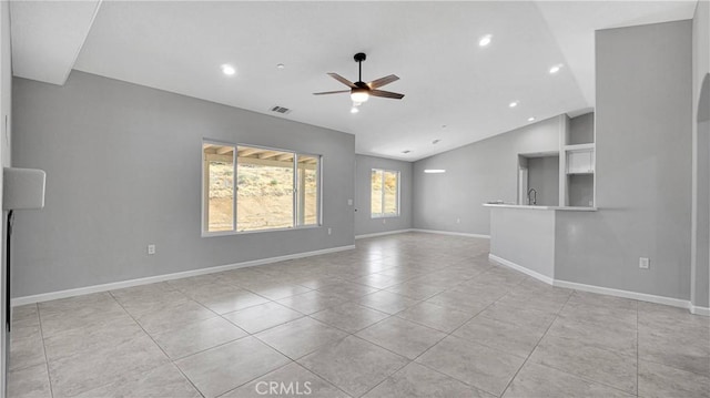 unfurnished living room with light tile patterned floors, vaulted ceiling, and ceiling fan