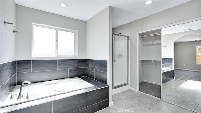 bathroom featuring tile patterned floors and separate shower and tub