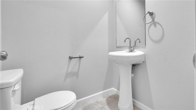 bathroom with tile patterned floors and toilet