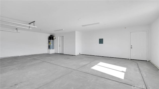 garage featuring secured water heater and electric panel