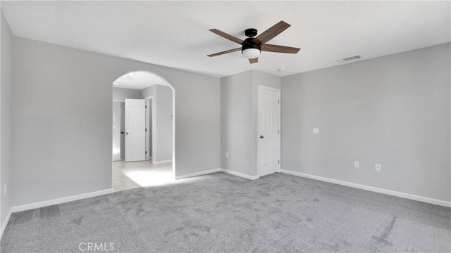 empty room with light colored carpet and ceiling fan