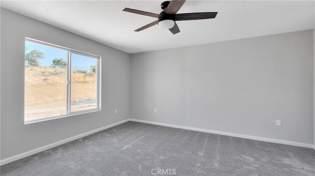 spare room with ceiling fan and carpet