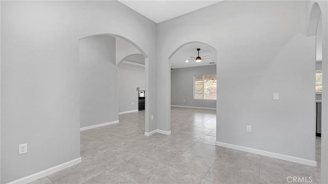 tiled empty room with ceiling fan