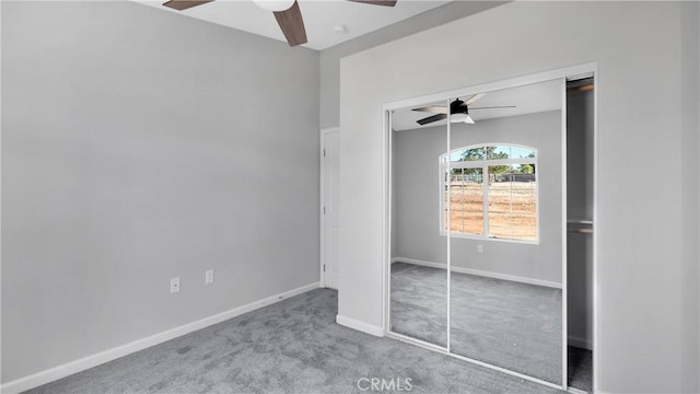 unfurnished bedroom featuring ceiling fan, light carpet, and a closet