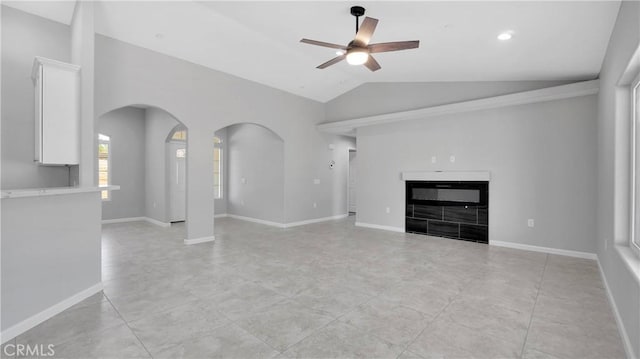 unfurnished living room with vaulted ceiling and ceiling fan