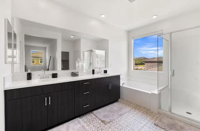 bathroom with tile patterned floors, vanity, and independent shower and bath