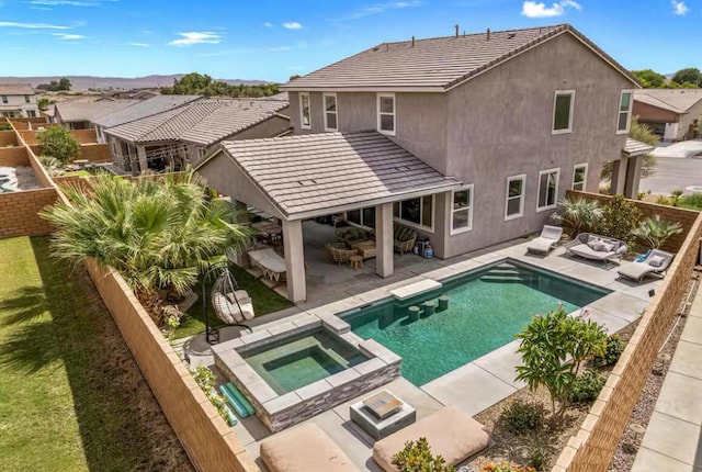 view of swimming pool with an in ground hot tub and a patio