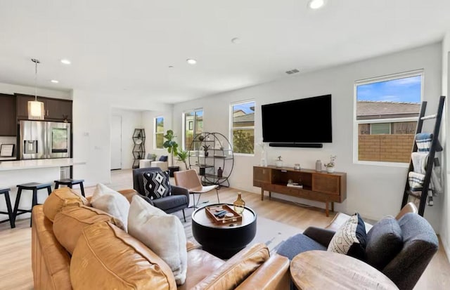 living room featuring light hardwood / wood-style flooring and plenty of natural light