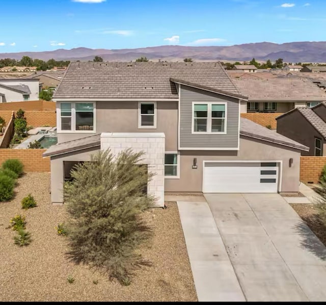 view of front of property featuring a mountain view and a garage