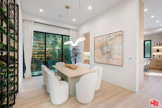 dining area featuring light wood-type flooring and a wealth of natural light