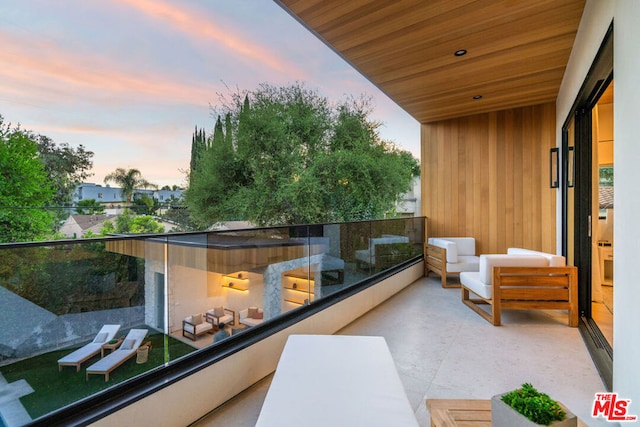 balcony at dusk with an outdoor hangout area