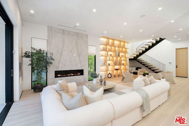 living room featuring a fireplace and light hardwood / wood-style flooring