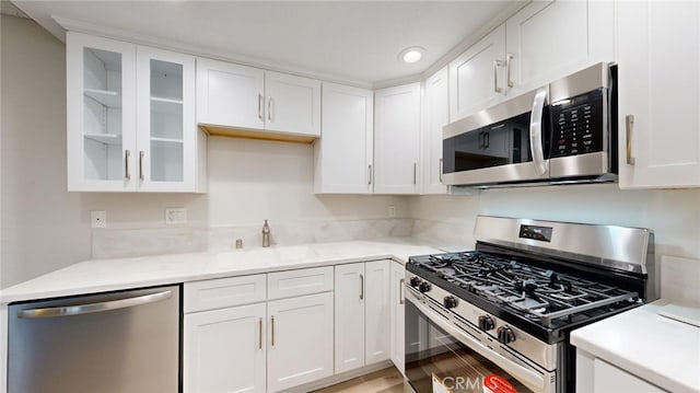 kitchen featuring white cabinets, sink, and stainless steel appliances