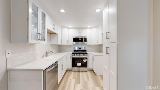 kitchen with white cabinetry, sink, and appliances with stainless steel finishes