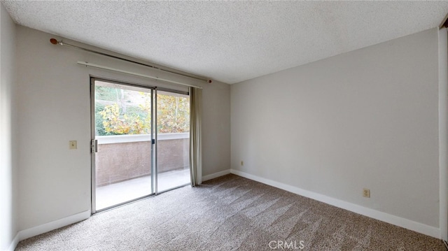 carpeted empty room with a textured ceiling