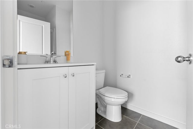 bathroom featuring tile patterned floors, vanity, and toilet