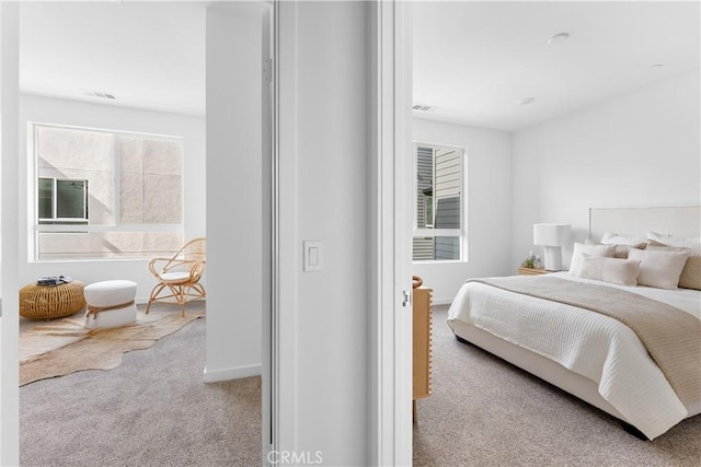 bedroom featuring light colored carpet