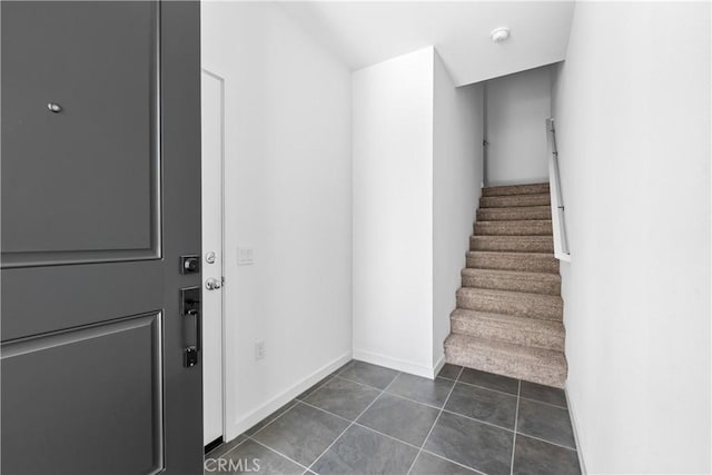 stairs featuring tile patterned flooring