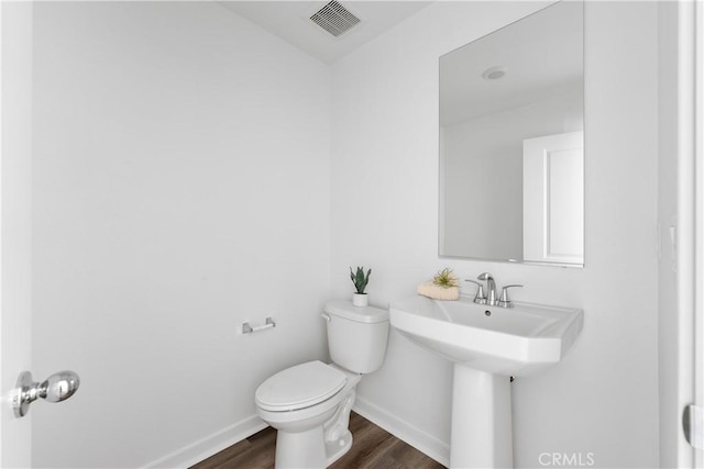 bathroom featuring hardwood / wood-style floors, toilet, and sink