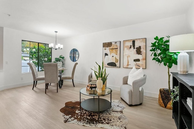 interior space featuring light hardwood / wood-style floors and an inviting chandelier