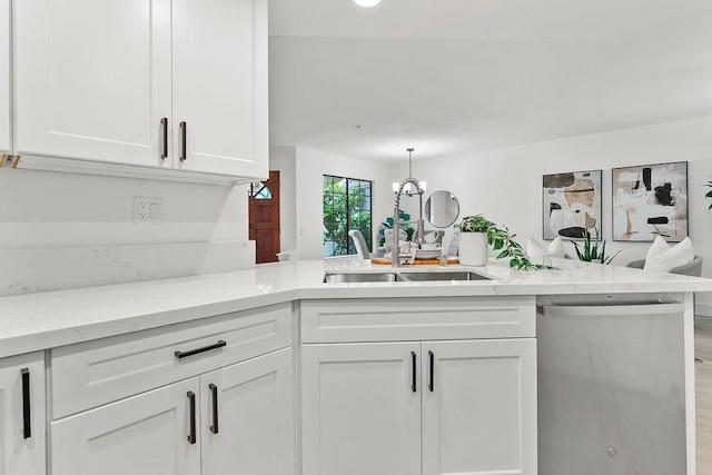 kitchen featuring dishwasher, white cabinetry, and kitchen peninsula