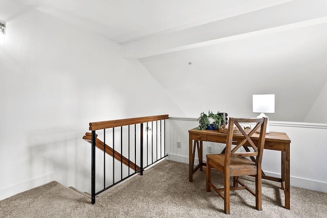 carpeted home office with vaulted ceiling