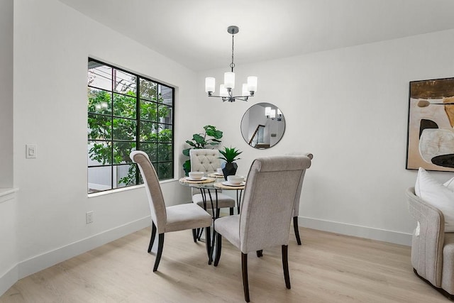 dining room featuring an inviting chandelier and light wood-type flooring