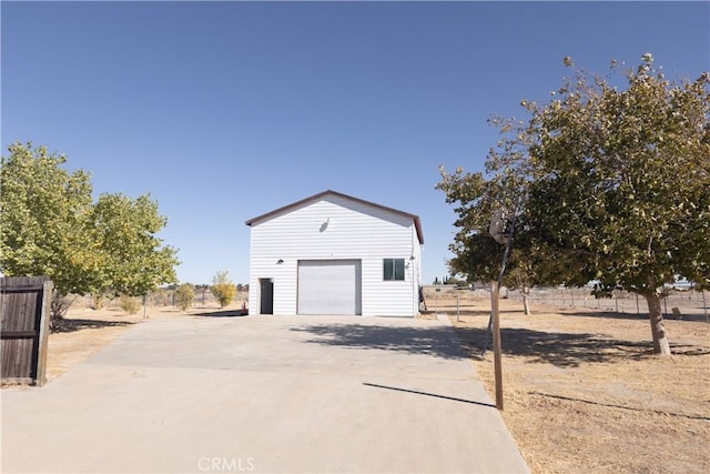 view of home's exterior featuring a garage and an outbuilding