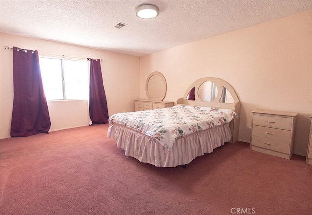 bedroom with a textured ceiling and light carpet