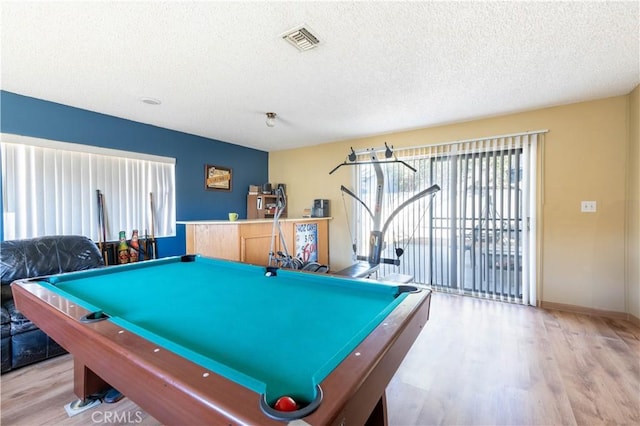 rec room with pool table, a textured ceiling, and light hardwood / wood-style flooring