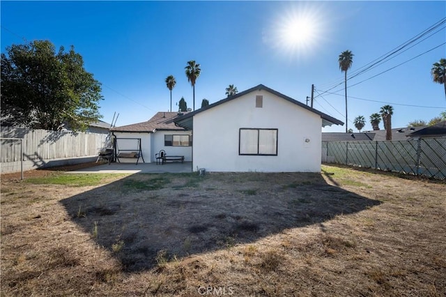 back of house with a patio