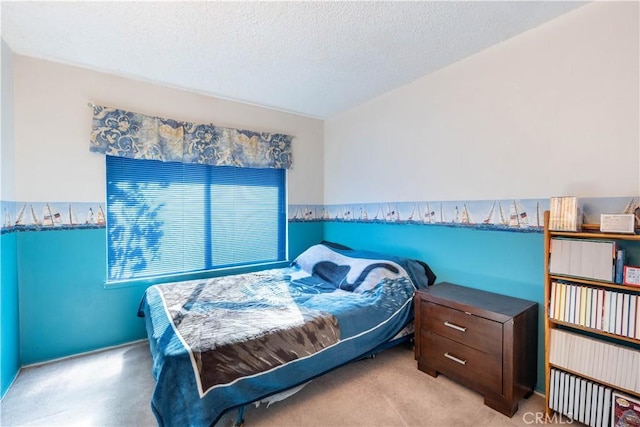 bedroom with light colored carpet and a textured ceiling