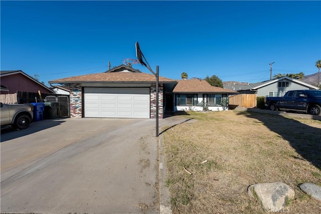 ranch-style house featuring a front yard and a garage