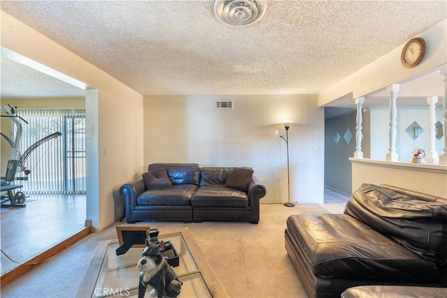 carpeted living room featuring a textured ceiling