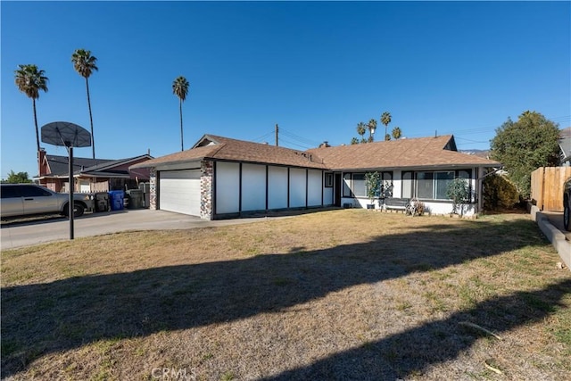 single story home with a front yard and a garage