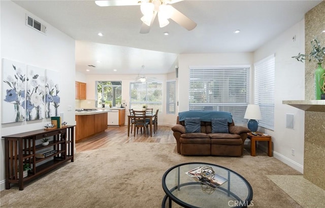 living room with ceiling fan and light hardwood / wood-style flooring