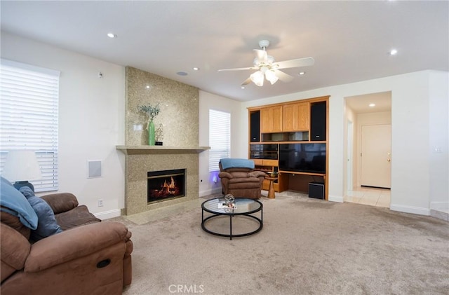 living room with ceiling fan, light colored carpet, and a healthy amount of sunlight