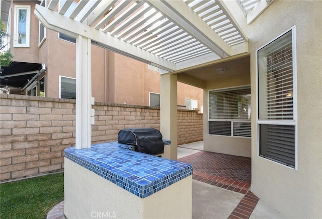 view of patio / terrace with a pergola and grilling area