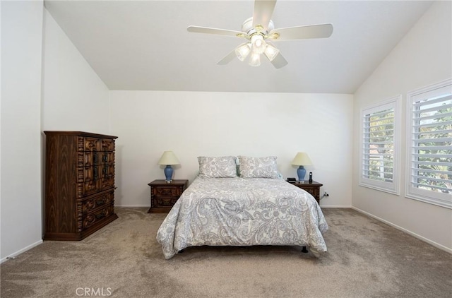 bedroom featuring light colored carpet, vaulted ceiling, and ceiling fan