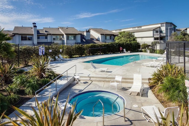 view of pool with a patio area and a community hot tub